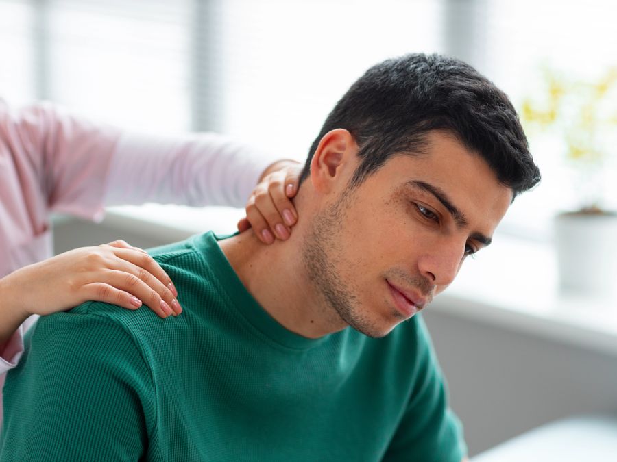 Physiotherapist treating a patient's neck and shoulder tension