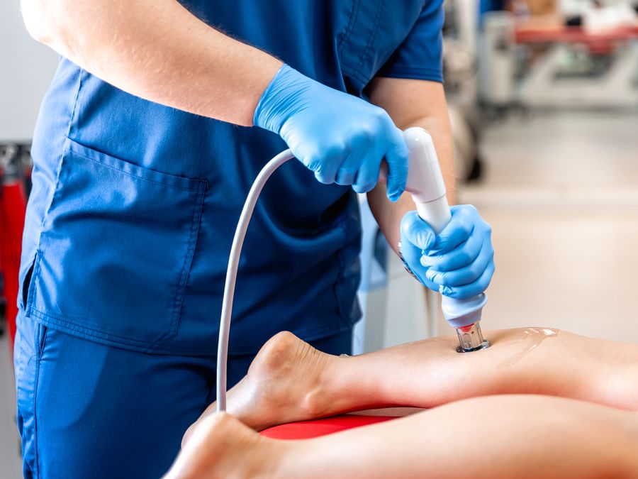 Extracorporeal shockwave therapy being applied to a patient's leg