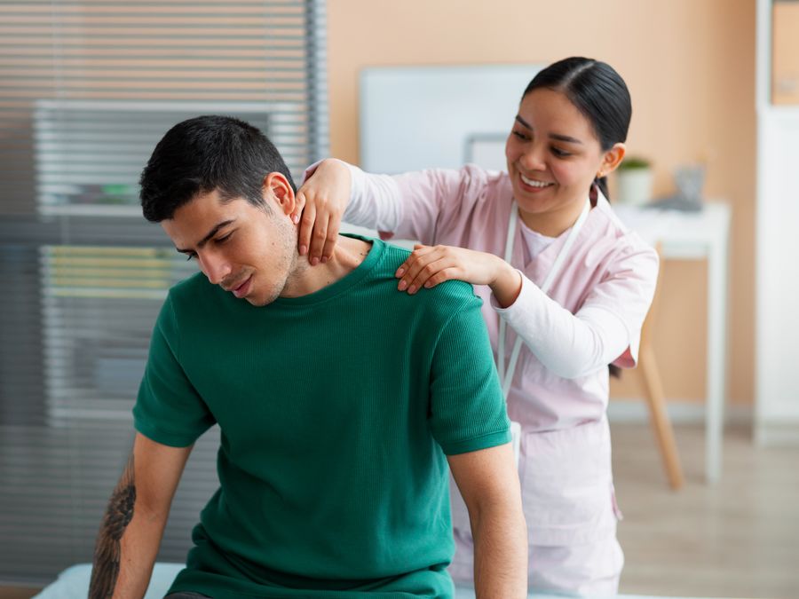 Therapist guiding a patient through shoulder mobility exercises